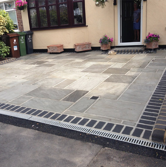 A image of one of many Driveways In Romford. The driveway has a pattern with different sized shapes bricks.